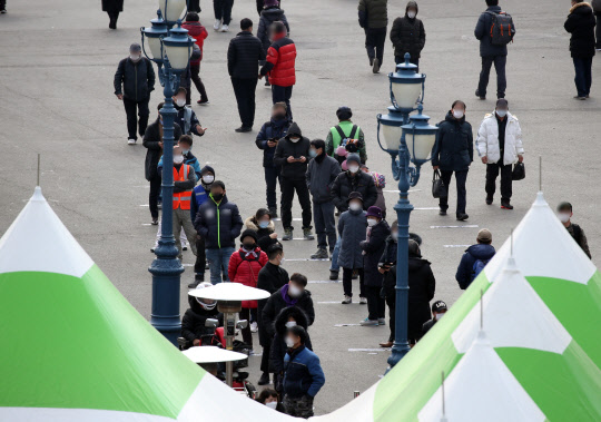 지난 19일 오후 서울 중구 서울역 광장에 설치된 신종 코로나바이러스 감염증(코로나19) 임시 선별 검사소에서 시민들이 검사를 기다리고 있다.       중앙방역대책본부는 이날 0시 기준으로 코로나19 신규 확진자가 561명 늘어 누적 8만6천128명이라고 밝혔다. 전날(621명)보다는 60명 줄었다.  연합뉴스